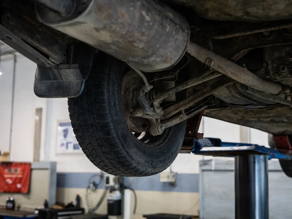 Vehicle raised for a wheel alignment check at The Tyre Warehouse Wellington